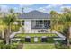 Beautiful backyard featuring a bocce ball court, a patio seating area, and lush tropical landscaping at 3546 Malta Ave, Wesley Chapel, FL 33543