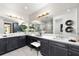 Modern bathroom with double vanity, sleek countertops, and lots of light at 3546 Malta Ave, Wesley Chapel, FL 33543