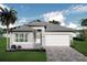 Charming single-story home with a paver driveway and lush landscaping at 3546 Malta Ave, Wesley Chapel, FL 33543