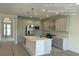 Modern kitchen featuring an island, stainless steel appliances, and ample cabinet space at 3546 Malta Ave, Wesley Chapel, FL 33543