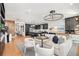 Open-concept living room with modern decor flowing into the kitchen and dining area at 3546 Malta Ave, Wesley Chapel, FL 33543