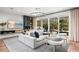 Bright living room with sliding glass doors leading to the outdoor entertainment area at 3546 Malta Ave, Wesley Chapel, FL 33543