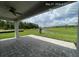 Spacious outdoor patio overlooking a serene pond, perfect for relaxation at 3546 Malta Ave, Wesley Chapel, FL 33543