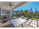 Outdoor entertainment area featuring ping pong, seating, and a well-manicured yard at 3546 Malta Ave, Wesley Chapel, FL 33543