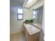 Bathroom featuring granite counters, tile flooring, a large mirror, and a skylight at 3621 102Nd N Pl, Clearwater, FL 33762