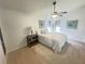 Cozy bedroom with a ceiling fan, wood floors, and artwork to create a warm, inviting space at 3621 102Nd N Pl, Clearwater, FL 33762
