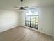 Bright bedroom with a large window, ceiling fan, and wood-look floors, creating a welcoming space at 3621 102Nd N Pl, Clearwater, FL 33762