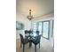 Elegant dining room with a modern chandelier and a glass-top table at 3621 102Nd N Pl, Clearwater, FL 33762