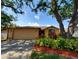 Charming single-story home featuring a well-manicured front yard with mulch and flowering plants at 3621 102Nd N Pl, Clearwater, FL 33762