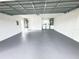 Spacious garage with epoxy flooring, laundry area, and water heater at 3621 102Nd N Pl, Clearwater, FL 33762