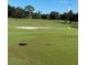 Beautiful green golf course with a sand trap and hole marked with a white flag at 3621 102Nd N Pl, Clearwater, FL 33762