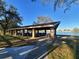 Community pavilion overlooking the lake, featuring picnic tables and a covered area for gatherings at 3621 102Nd N Pl, Clearwater, FL 33762