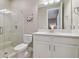 Bright bathroom featuring a tiled shower, white cabinets and quartz counters at 4165 San Severo Rd, Wesley Chapel, FL 33543