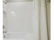Bright bathroom featuring a clean white tiled tub and shower area, offering a fresh and modern feel at 4165 San Severo Rd, Wesley Chapel, FL 33543
