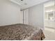 Bedroom with neutral walls, carpet, and a bathroom nearby at 4165 San Severo Rd, Wesley Chapel, FL 33543