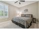 Comfortable bedroom featuring a queen bed, neutral decor, and window at 4165 San Severo Rd, Wesley Chapel, FL 33543
