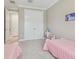 Cozy bedroom with two toddler beds, closet, and neutral walls at 4165 San Severo Rd, Wesley Chapel, FL 33543