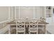 Formal dining room with decorative wall trim, stylish chairs, and modern chandelier at 4165 San Severo Rd, Wesley Chapel, FL 33543