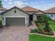 Charming single-story home with well-manicured landscaping and a brick driveway at 4165 San Severo Rd, Wesley Chapel, FL 33543