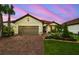 Charming single-story home with a well-manicured lawn and a beautiful flower bed at 4165 San Severo Rd, Wesley Chapel, FL 33543