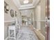 Welcoming foyer with views into the home's living area, enhanced by neutral decor and decorative lighting fixtures at 4165 San Severo Rd, Wesley Chapel, FL 33543
