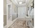 Charming foyer with decorative molding, stylish console table, and a view of the front door with sidelights at 4165 San Severo Rd, Wesley Chapel, FL 33543
