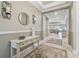 Elegant foyer featuring neutral tones, decorative mirrors, and an open view into the bright living space at 4165 San Severo Rd, Wesley Chapel, FL 33543