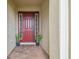 Inviting entryway with a red front door framed by sidelights and potted plants for added curb appeal at 4165 San Severo Rd, Wesley Chapel, FL 33543