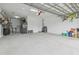 Spacious two-car garage featuring epoxy flooring and ample storage space at 4165 San Severo Rd, Wesley Chapel, FL 33543