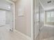 Hallway with wood floors and doorways to various rooms at 4165 San Severo Rd, Wesley Chapel, FL 33543