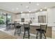 Modern kitchen with white cabinetry, stainless steel appliances, a large island, and barstool seating at 4165 San Severo Rd, Wesley Chapel, FL 33543