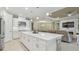 Open-concept kitchen with white cabinets, stainless steel appliances, and a large island at 4165 San Severo Rd, Wesley Chapel, FL 33543