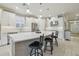 Bright modern kitchen featuring a large center island with seating, stainless steel appliances, and white cabinetry at 4165 San Severo Rd, Wesley Chapel, FL 33543