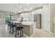 Modern kitchen features white cabinetry, stainless steel appliances, a large island, and barstool seating at 4165 San Severo Rd, Wesley Chapel, FL 33543