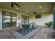 Screened lanai featuring brick pavers, ceiling fans, and outdoor dining area at 4165 San Severo Rd, Wesley Chapel, FL 33543