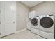 Laundry room featuring side-by-side washer and dryer and built-in cabinets at 4165 San Severo Rd, Wesley Chapel, FL 33543