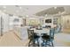 Spacious living area with an open layout featuring a modern white kitchen and connected fireplace and tv at 4165 San Severo Rd, Wesley Chapel, FL 33543