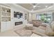 Comfortable living room features a fireplace, built-in shelving, and sliding doors to the outdoor patio at 4165 San Severo Rd, Wesley Chapel, FL 33543