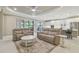 Bright and airy living room featuring neutral tones, ceiling fan, and access to outdoor living space at 4165 San Severo Rd, Wesley Chapel, FL 33543