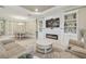 Inviting living area with a fireplace, built-in bookshelves, and a dining area at 4165 San Severo Rd, Wesley Chapel, FL 33543