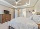 Relaxing main bedroom with neutral tones, tray ceiling, and en-suite bathroom at 4165 San Severo Rd, Wesley Chapel, FL 33543