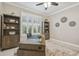 Cozy office space with wood-look floors, a ceiling fan, and built-in bookcases at 4165 San Severo Rd, Wesley Chapel, FL 33543