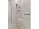 Modern shower with neutral tile, a built-in seat, and a glass enclosure at 4165 San Severo Rd, Wesley Chapel, FL 33543