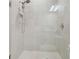 Large walk-in shower featuring white tiles and a rainfall shower head at 4165 San Severo Rd, Wesley Chapel, FL 33543