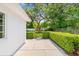 Large backyard featuring a well-maintained lawn, mature trees, established landscaping, and a side patio at 417 Broadway, Dunedin, FL 34698