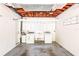 Open basement laundry area featuring a utility sink, washer, dryer, and ample storage space at 417 Broadway, Dunedin, FL 34698