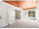 Bonus room showcases wood paneled ceiling, natural light, and open access to the living room and kitchen at 417 Broadway, Dunedin, FL 34698