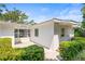 Charming home exterior with a white facade, well-manicured landscaping, and a welcoming entrance at 417 Broadway, Dunedin, FL 34698