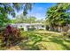 Charming single-story home with a lush front yard and mature landscaping, perfect for curb appeal at 417 Broadway, Dunedin, FL 34698