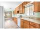 Well-lit kitchen featuring wood cabinets, plenty of counter space, and access to the living room at 417 Broadway, Dunedin, FL 34698
